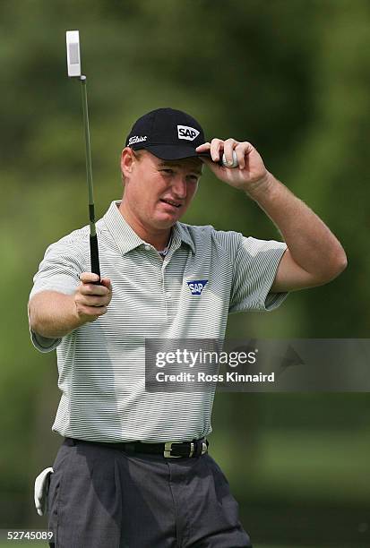 Ernie Els of South Africa tips his hat to the crowd during the delayed final round of the BMW Asian Open at the Tomson Golf Club on May 2, 2005 in...