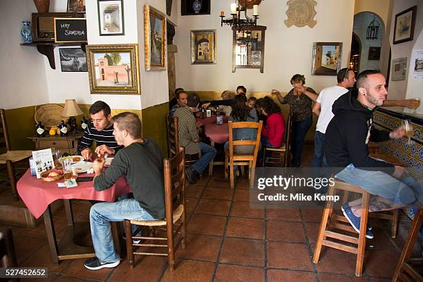 People inside having lunch in Alhama de Granada tapas Bar Ochoa. Traditional food in a traditional place. Alhama de Granada is a town in the province...