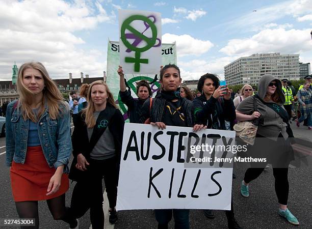 Protest against austerity organised by UK Uncut May30th 2015. Sisters Uncut group with banner and young woman carrying a placard saying 'Austerity...