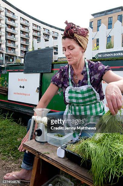 Mile End Park floating market - making wheat grass juice, London, UK.