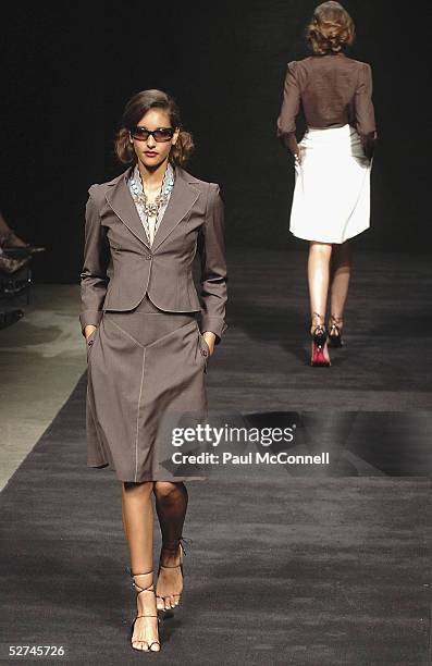 Model walks down the runway during the Jayson Brunsdon Collection show at the Cargo Hall in the Overseas Passenger Terminal during the Mercedes...