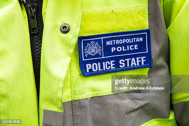 Police Community Support Officer's badge on the beat in Greater London, UK.
