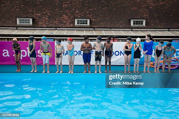 Children from Devonshire Hill Primary School in Tottenham, London, UK, take part in a 1 hour swimming session at a pop-up pool at their school to...