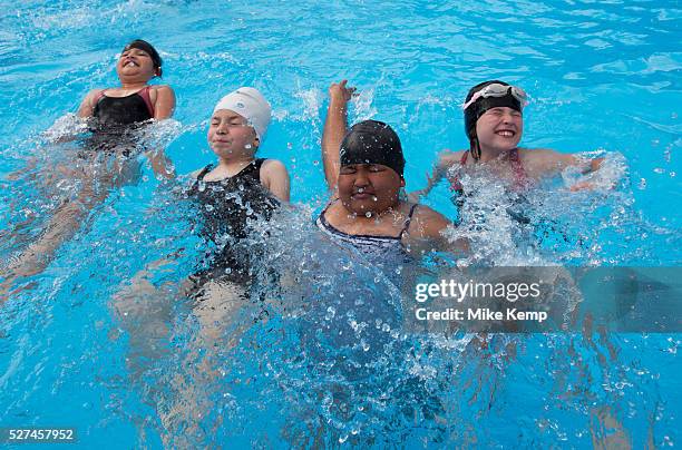 Children from Devonshire Hill Primary School in Tottenham, London, UK, take part in a 1 hour swimming session at a pop-up pool at their school to...