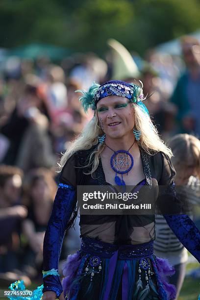 People dressed in Morris dancing attire perform for crowds visitors, english traditions. The annual Beltane celebrations at Butser ancient farm,...