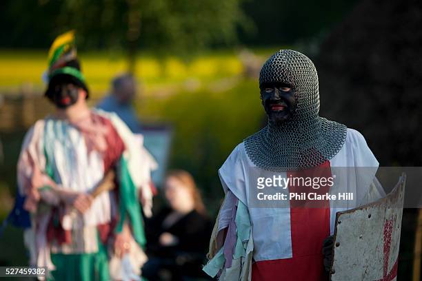 Men dressed as knights re-enactors doing a pretend battle, perform for crowds visitors, english traditions. The annual Beltane celebrations at Butser...