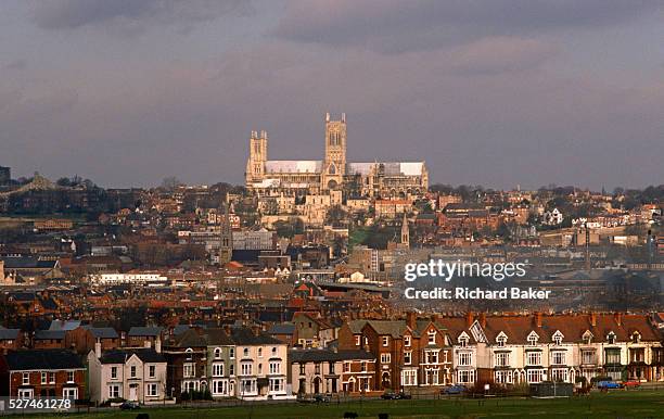 Lincoln Cathedral sits high on the skyline, across the city from terraced housing. In the distance, the cathedral stands dominating the city....