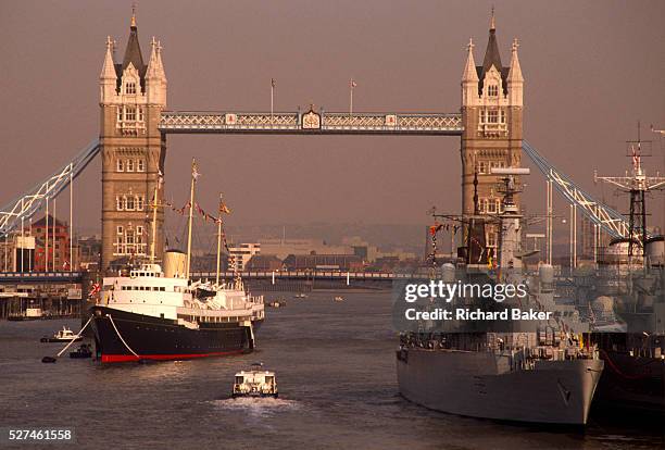 The Royal Yacht Britannia visits the Thames at Tower Bridge to honour the Queen Mother's 90th birthday in Aug 1990. Moored midstream in the river,...