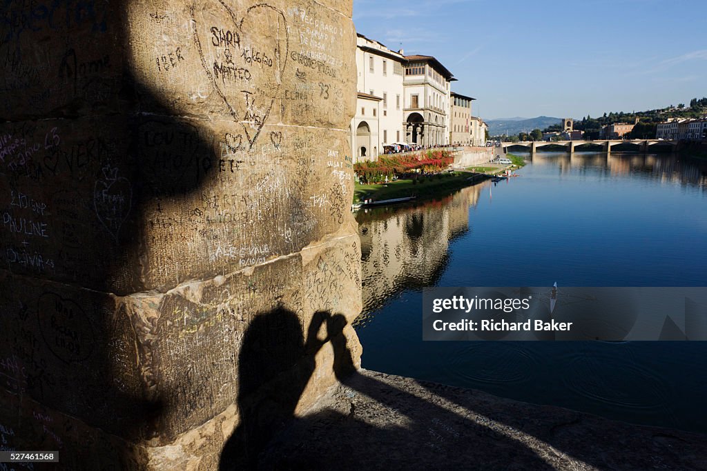 Italy - Florence - Ponte Vecchio graffiti and tourist shadow