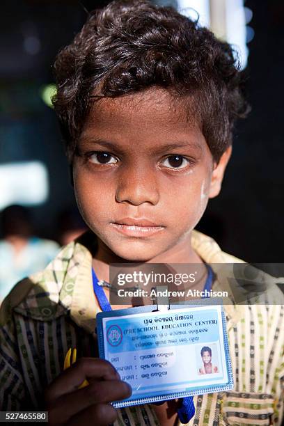 Young boy with his school identity card organised by CLAP, Committee for Legal Aid to Poor is a non-profit organisation helping to provide legal aid...