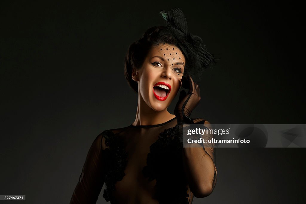 Mid adult women wearing black gown Glamourous retro diva singing