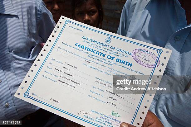 Children from the Dobhanda Nagar slum in Cuttack receive birth certificates from the Urban Law centre run by the organisation CLAP. Committee for...