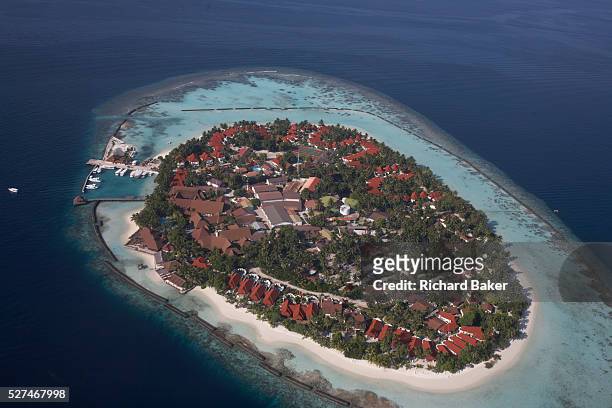 An aerial view of an unidentified island community seen from a regional aircraft passing overhead atolls and islands, a few miles to the north Mal',...