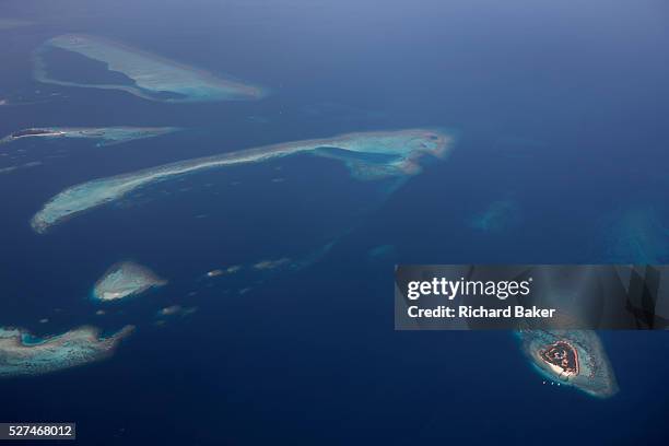 An aerial view of unidentified islands seen from a regional aircraft passing overhead the atolls and islands to the north Mal', capital of the Indian...