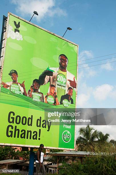 Ghana July 2012. Road to Cape coast. Mobile phone advert for Glo Ghana, the country's fifth largest mobile phone provider which launched in April 2012