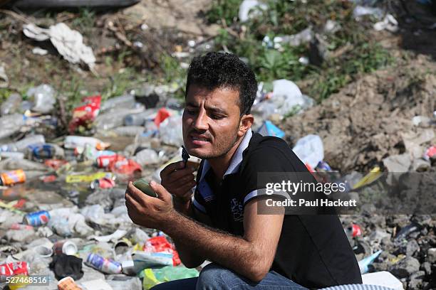 Man has a shave at 'the Jungle' migrant camp in Calais, France, August 10, 2015. The Calais jungle is the nickname given to a series of camps in the...
