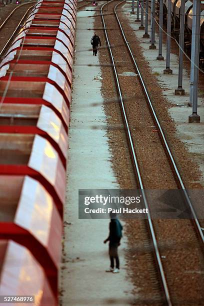 Migrants walk along the railway track leading to the EuroTunnel at night, in Calais, France, August 10, 2015. Migrants are attempting to enter the...