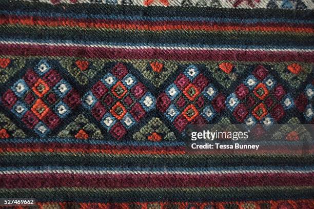 Close up of a woollen yathra blanket from the Bumthang region in central Bhutan. Yathra is a hand woven fabric made from the wool of sheep and yak...