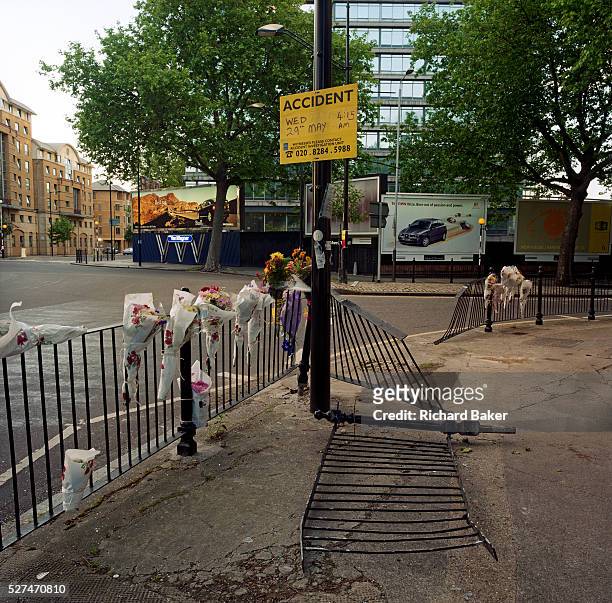 In front of car ad billboards, a memorial has been placed where 'Jay' died on St George's Circus, London, England. If we drove past this place where...