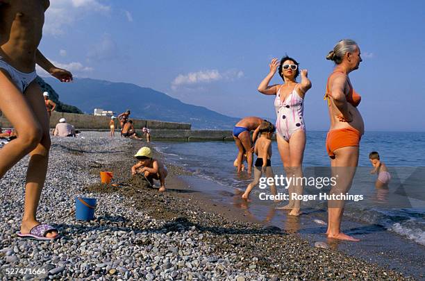 People at the beach bathing,swimming and sunbathing