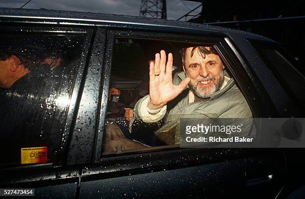 The former Beirut hostage, Terry Waite waves from a car, driven away after landing back at RAF Lyneham, UK. Looking exhausted, with red eyes, a drawn...