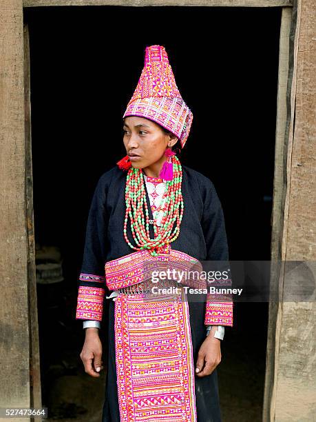 Married Ko Pala ethnic minority woman wears her traditional costume at home, Ban Honglerk, Phongsaly Province, Lao PDR. The brightly coloured,...