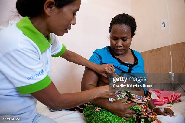 Health worker Santina pumps milk out of Flaviana. Flaviana gave birth to baby girl Maria the day before but the Maria has fever and kept in the...