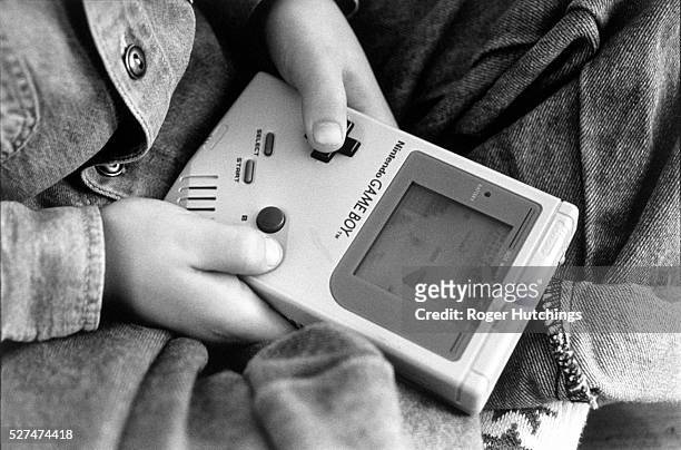 London - A boy playing on one of the first Nintendo Game Boy computers