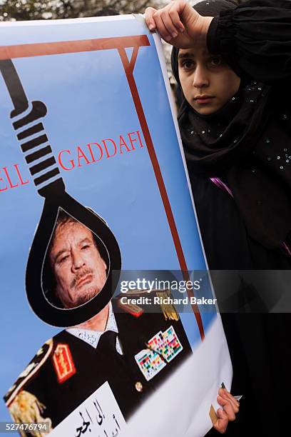 During the Libyan uprising, a young girl in Islamic dress demands the hanging of Colonel Gaddafi during protests opposite London Libyan embassy...