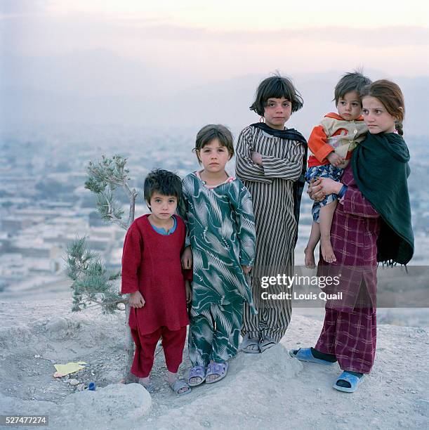 Young Afghan girls Historai Sheba Rifer Soloha and Tina, 4 on a hilltop overlooking Nadir Shah and Kabul. Children have been the primary victims of...