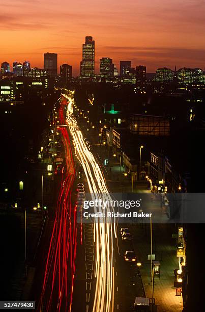 The Mile End Road leading up to the City of London with the Natwest tower on the horizon. The evening exodus is underway, the rush-hour for commuters...