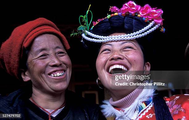 Mu Ze Latso shares a joke and an intimate moment with her mother Mu Ze Namu. They belong to the Mo Suo tribe from Lugu Lake, northwest Yunnan...