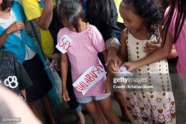 Girls performing in a play on child sex trafficing and abuse in a Manila slum. Because of poverty and lack of income children and young women are...