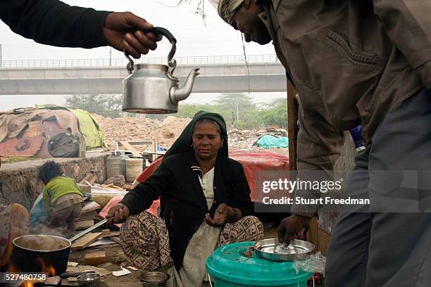 Sheela at her tea stall on waste ground near Nehru Place. Sheela came to Delhi in 1981 from Rajasthan with her husband and three children. Over the...