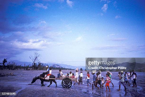 Villagers cross an enlarged river bed after Mount Pinatubo volcanic eruption which caused the displacement of thousands of villagers that surround...