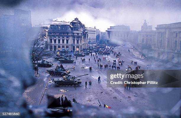 View of Bucharest's central Square surrounded by tanks and bombed out buldings after the Romanian revolution ousted the dictator Ceucescu from power...