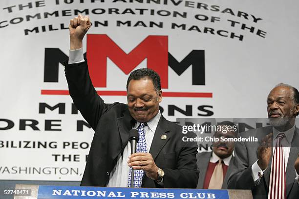 Rev. Jesse Jackson takes the podium as District of Columbia Council member Marion Barry applauds during a news conference to discuss the 10th...