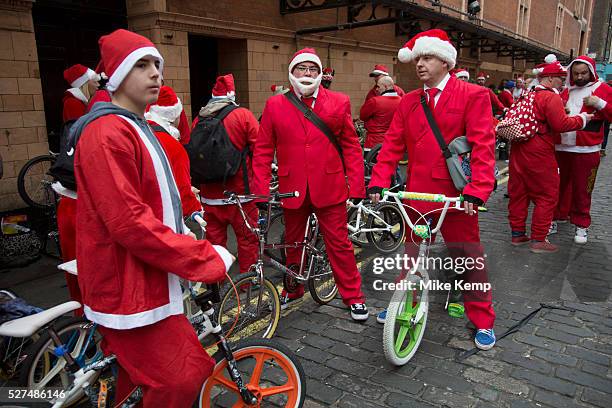 Members of Old School BMX Life on the Santa Cruise charity day out in Soho, London, UK. All dressed up wearing Santa Claus outfits and sporting fine...