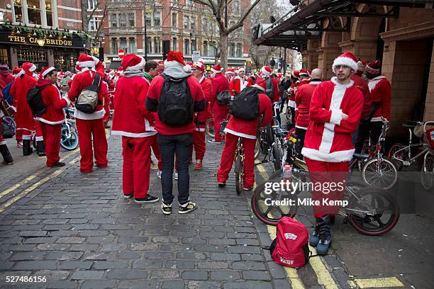 Members of Old School BMX Life on the Santa Cruise charity day out in Soho, London, UK. All dressed up wearing Santa Claus outfits and sporting fine...