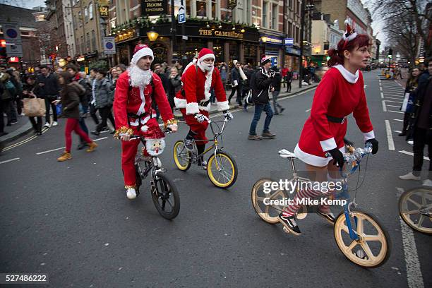 Members of Old School BMX Life on the Santa Cruise charity day out in Soho, London, UK. All dressed up wearing Santa Claus outfits and sporting fine...