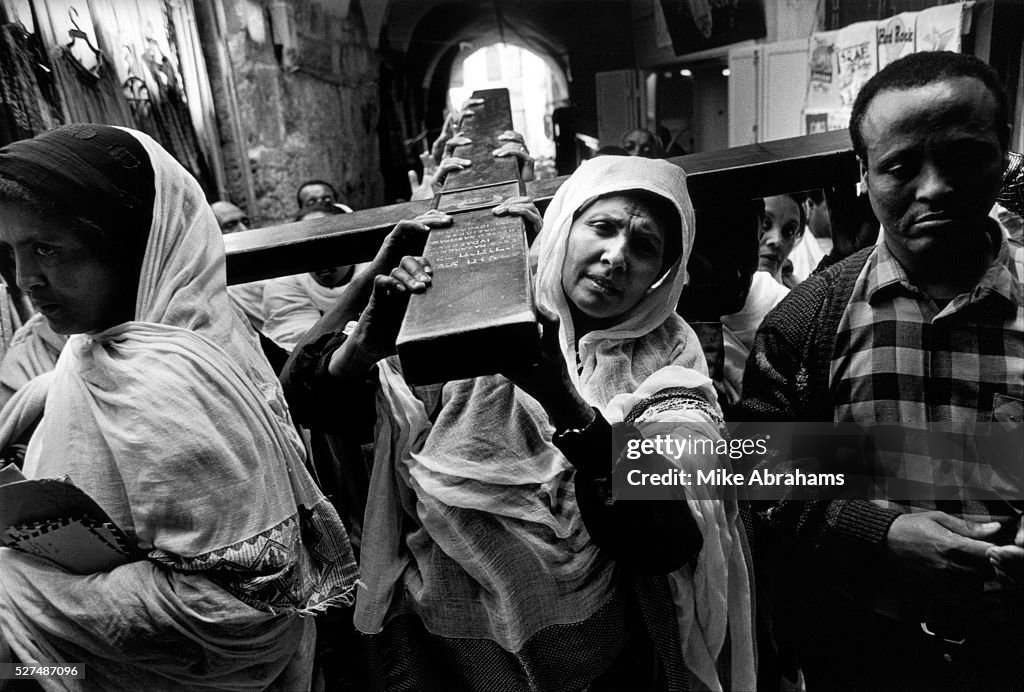 Israel - Jerusalem - The Via Dolorosa - pilgrims carry a cross during Easter celebrations