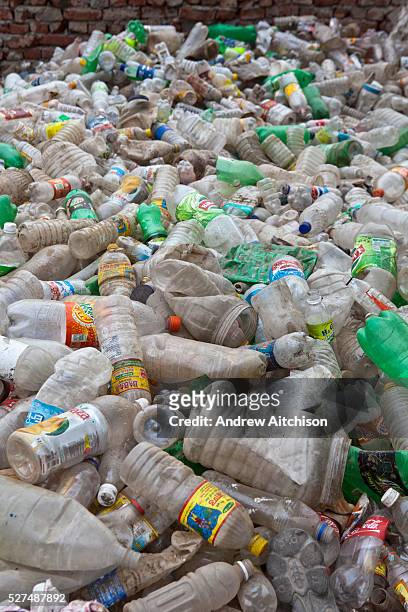 Tehkhand Slum, Delhi , India. Plastic bottles that a family have collected from the streets and rubbish tips to sell to local dealers. Many slum...