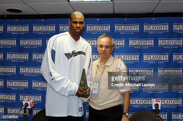 Antawn Jamison of the Washington Wizards poses with the 2005 Magic Johnson Award, awarded by Sam Smith of the Chicago Tribune before the game against...