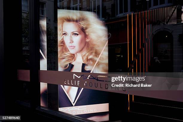 The singer, Ellie Goulding's face seen in the window of her own cosmetic brand Mac Cosmetics, in London's Carnaby Street. The pop singer has her name...