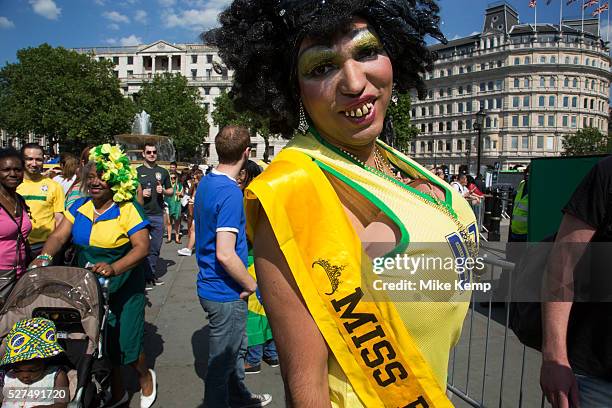 London, UK. Thursday 12th June 2014. A grotesque Miss Brazil drag beauty queen with wig and buck teeth and giant fake breasts. Brazilians gather for...