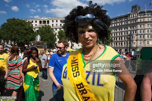 London, UK. Thursday 12th June 2014. A grotesque Miss Brazil drag beauty queen with wig and buck teeth and giant fake breasts. Brazilians gather for...