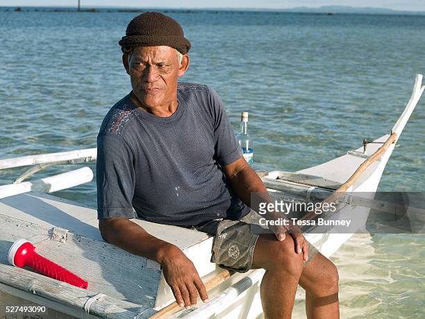 Fisherman Roberto Cabrara sits on his fishing boat before heading out to sea, Talisay, Santa Fe, Bantayan Island, The Philippines. On November 6 2013...