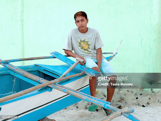 Portrait of fisherman Robert Illut sitting on a pump boat, Talisay, Santa Fe, Bantayan Island, The Philippines. On November 6 2013 Typhoon Haiyan hit...