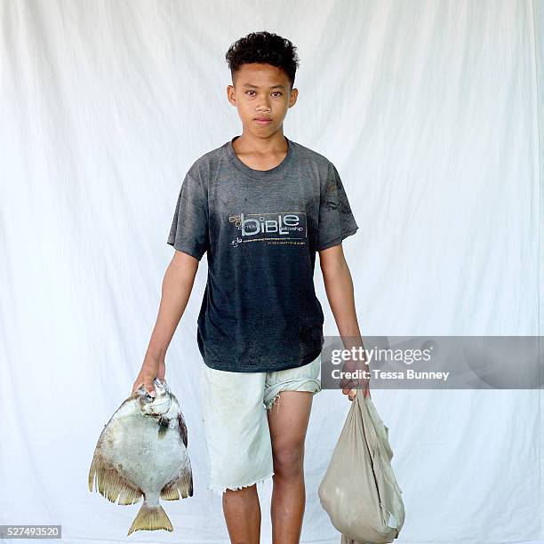 Rolly Lanbab Jr , fisherman, Pooc, Bantayan Island, The Philippines. Every morning at 7 am fisherwomen meet fishermen as they return from the sea...