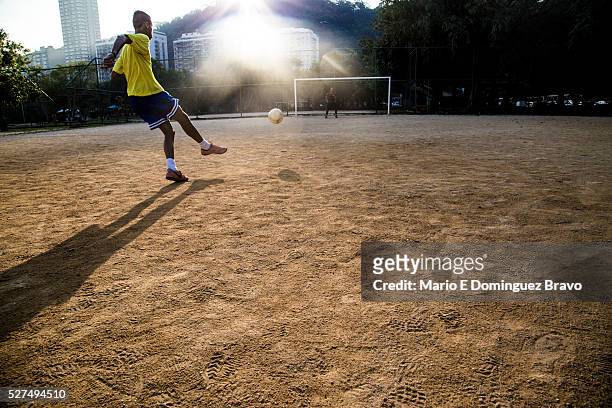 Two boys playing football in one of the courts of Lagoa. It is the 16th, the first day in which no scheduled World Cup matches. One day before the...
